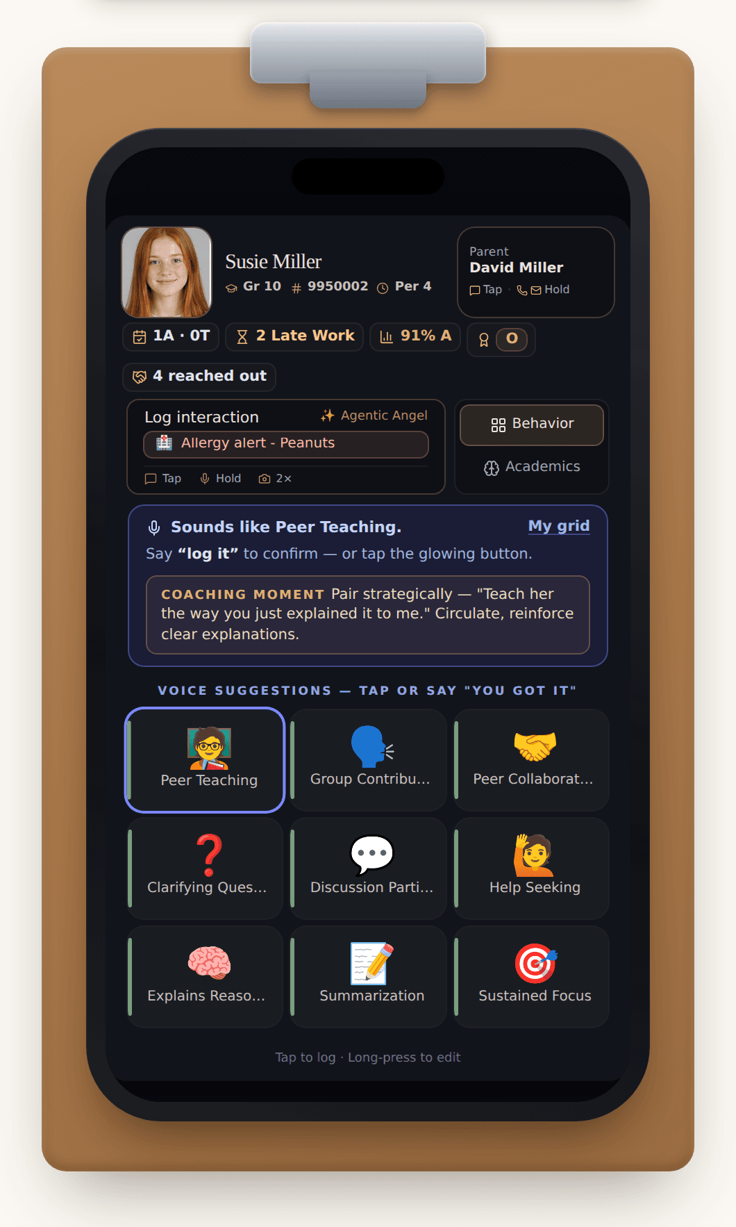 An iPhone clipped to a teacher's clipboard, showing a Teacher Supreme student card for demo student Susie Miller: a voice suggestion reading 'Sounds like Peer Teaching' with 'say log it to confirm — or tap the glowing button', a Coaching Moment tip ('Pair strategically — teach them the way you just explained it to me'), and nine suggestion buttons with Peer Teaching glowing